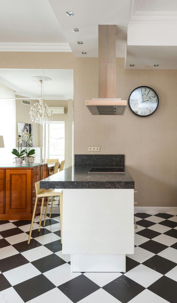 Black and white tiled kitchen floor in a Swansea home.